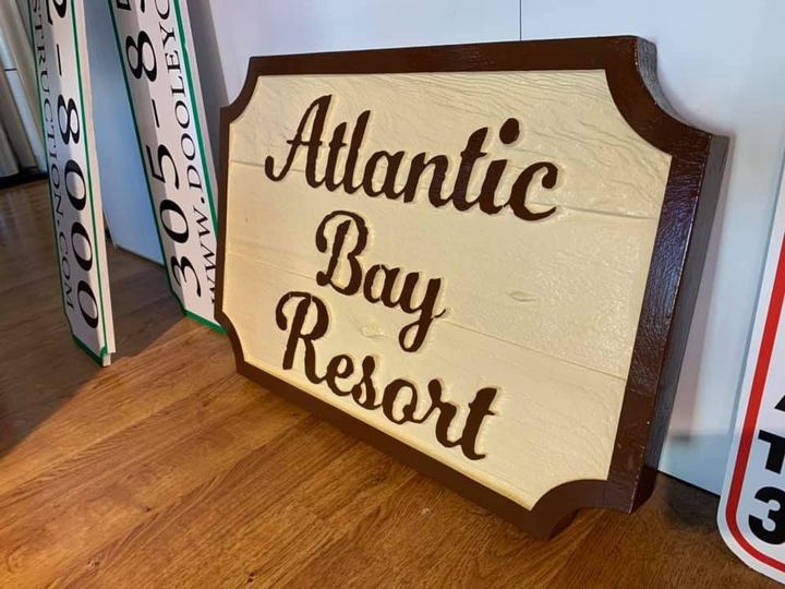 Carved Atlantic Bay Resort sign with script lettering