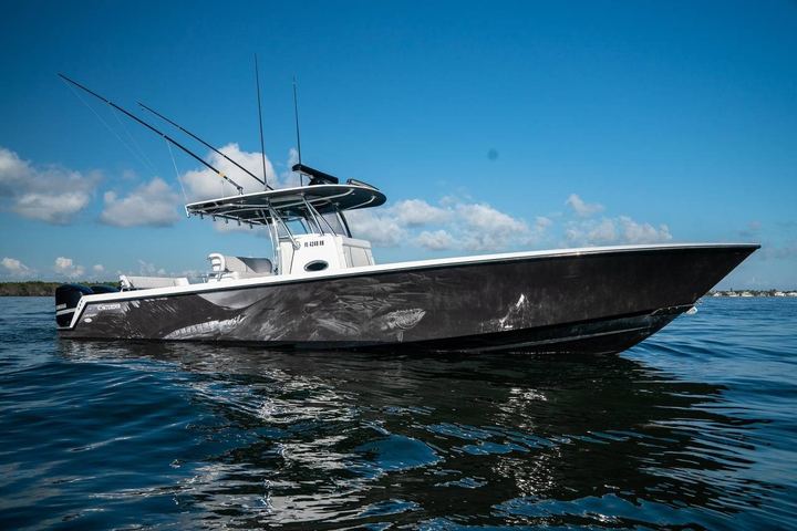 Black center console with game fish art wrapped along the hull