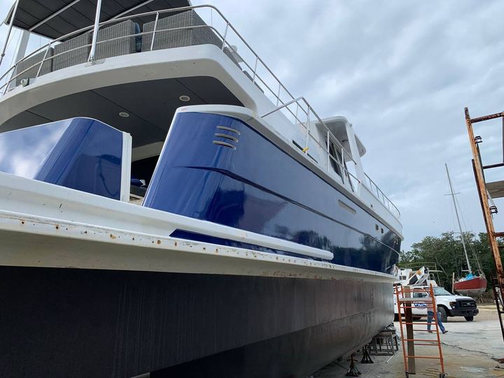 Bow of the big power catamaran wrapped in deep blue