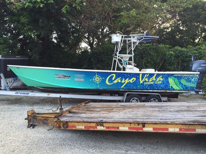 Teal Cayo Vida center console on a trailer with a full wrap