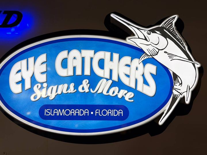 Lit oval Eye Catchers Signs and More cabinet sign with a cut-out marlin