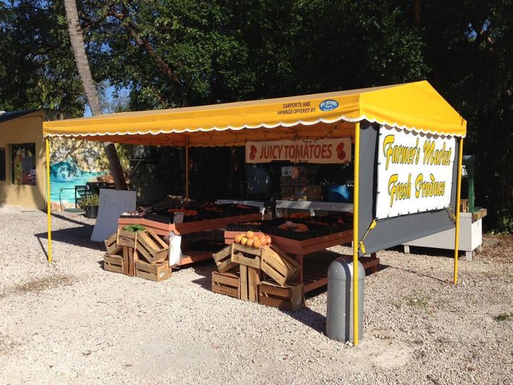 Yellow awning over a farmers market stand