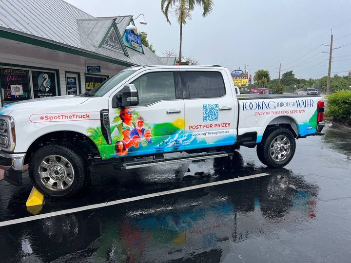 Pickup truck wrapped for the movie Looking Through Water with a QR code and water graphics