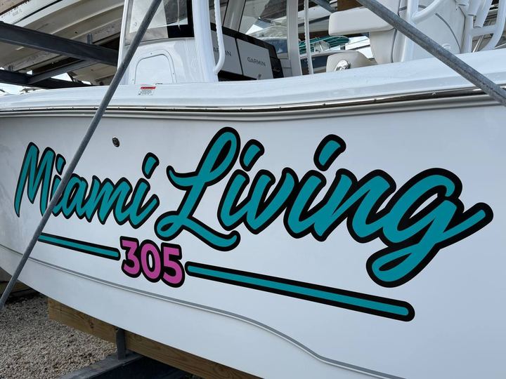 Miami Living 305 script lettering in teal and pink on a white center console