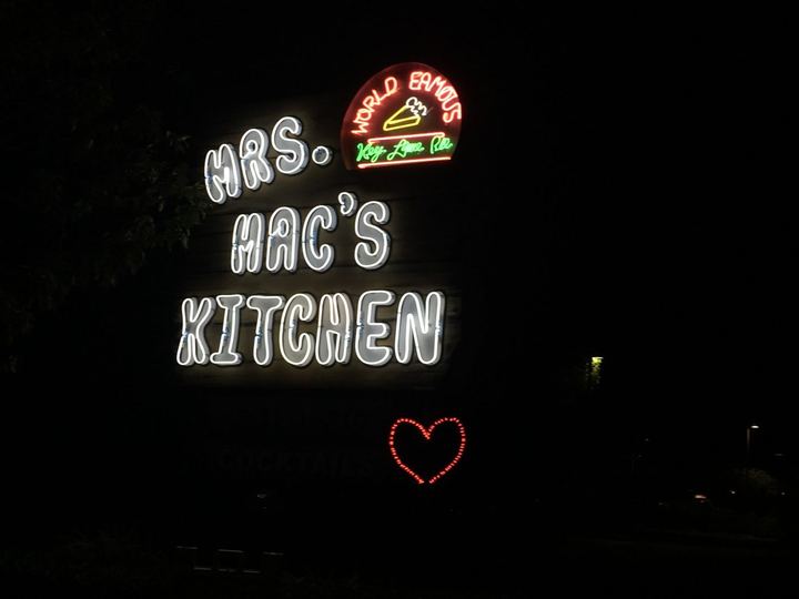 Glowing Mrs. Mac's Kitchen sign at night