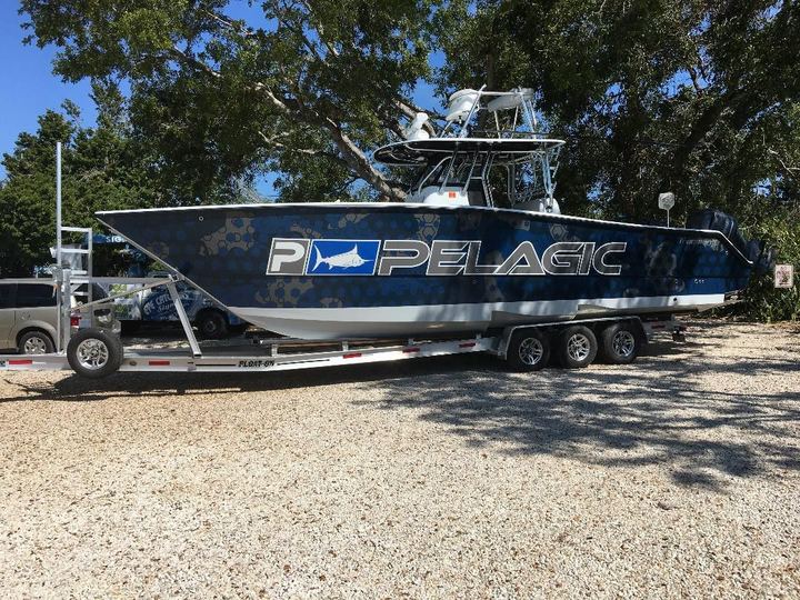 Center console on a trailer with a black and gray Pelagic wrap