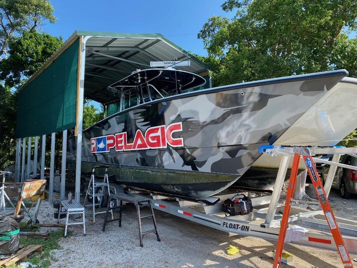 Center console with a gray camo wrap and Pelagic logo