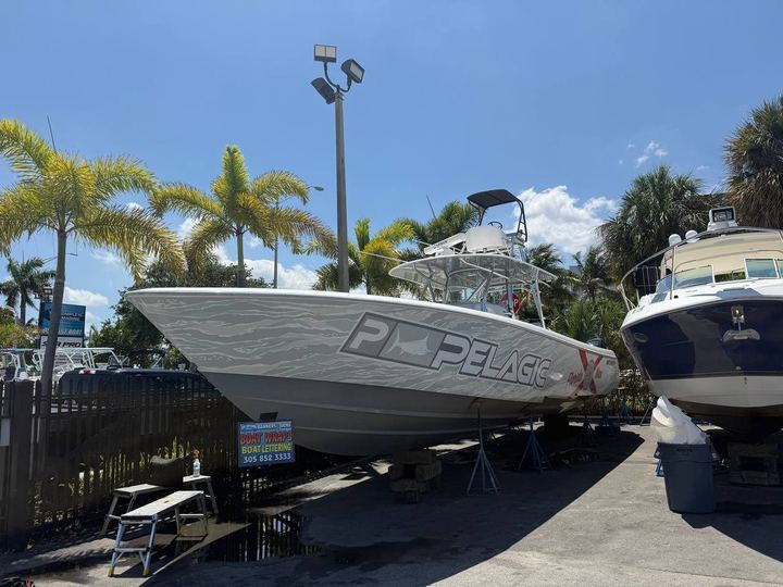Center console on stands with a gray striped wrap and Pelagic logo