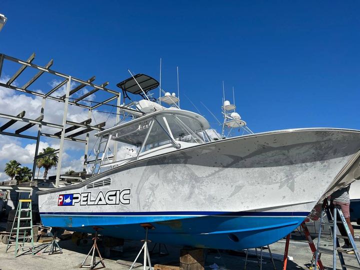 Center console on stands with a white and gray wrap, blue boot stripe and Pelagic logo