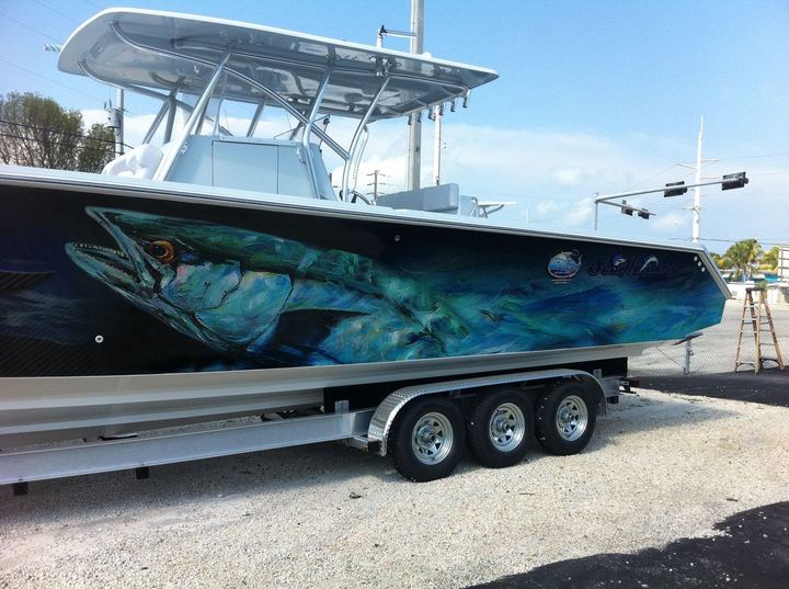 Center console with a giant tarpon wrapped along the hull