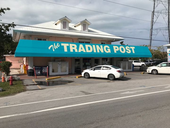 Teal awning lettered The Trading Post across a storefront