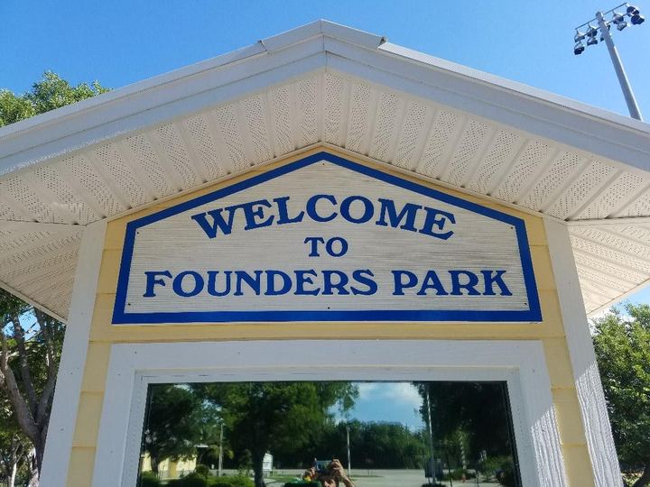 Welcome to Founders Park sign under a gabled roof