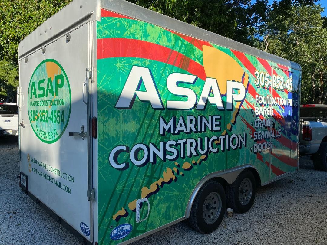 Enclosed trailer fully wrapped in green and orange for ASAP Marine Construction