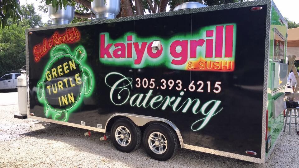 Black catering trailer wrapped with glowing Sid and Roxie's Green Turtle Inn and Kaiyo Grill and Sushi graphics