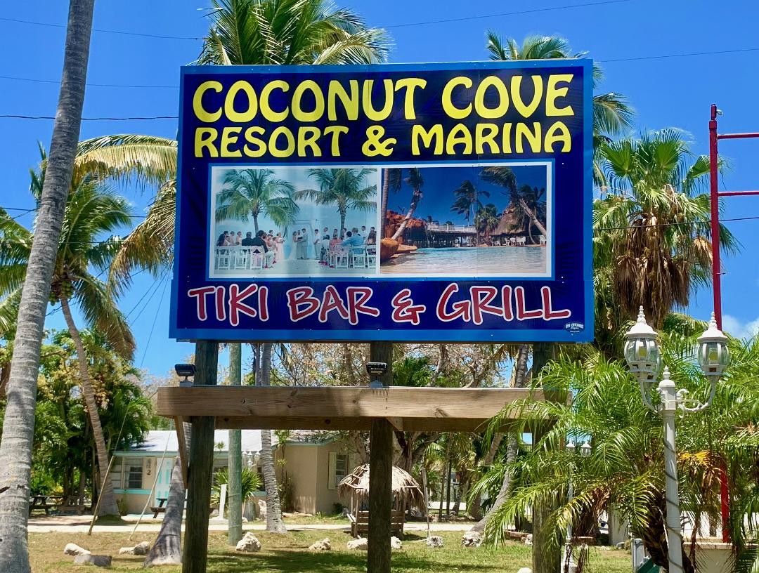 Lit Coconut Cove Resort and Marina sign