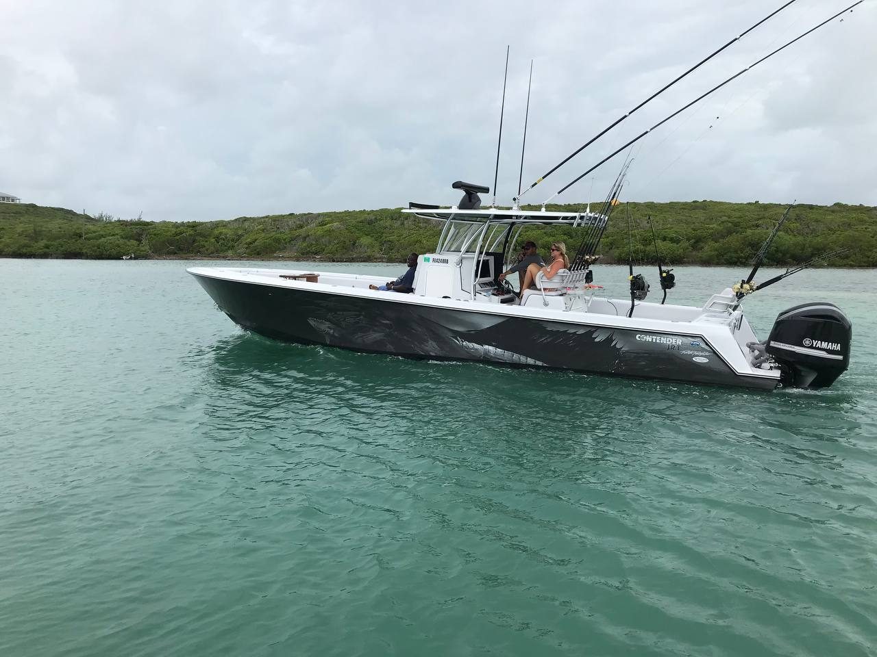 Contender center console with gray game fish art running in green water