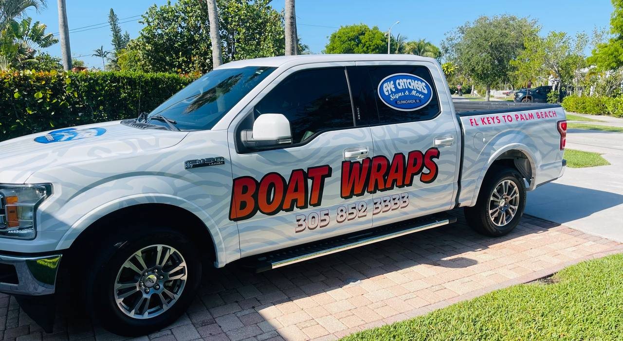 Our white pickup lettered Boat Wraps with our phone number