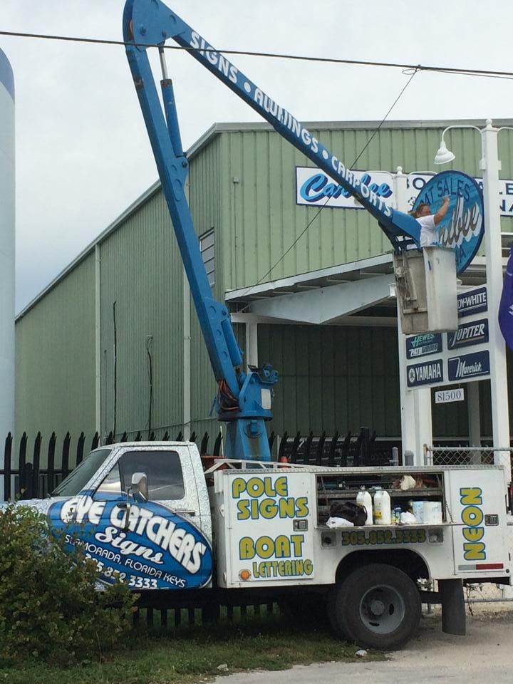 Eye Catchers Signs bucket truck at a sign install