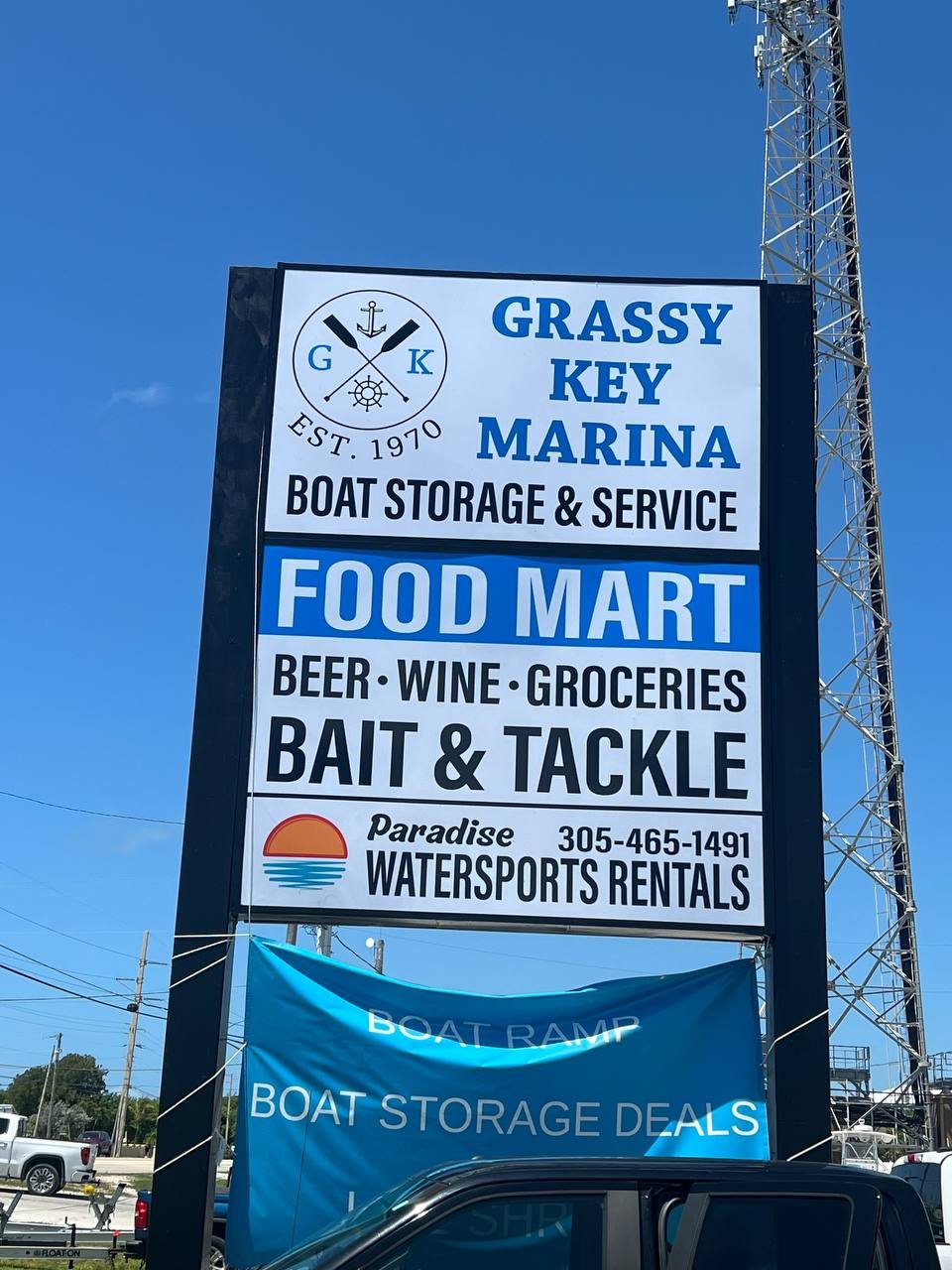 Grassy Key Marina pole sign with Food Mart, Bait and Tackle and watersports rental panels