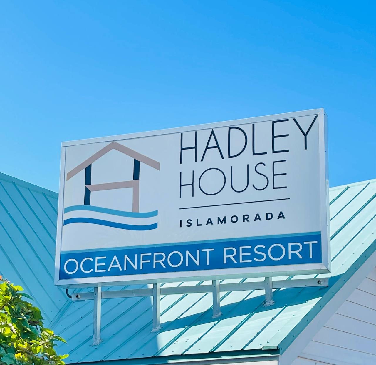 Hadley House Islamorada Oceanfront Resort sign on a teal metal roof