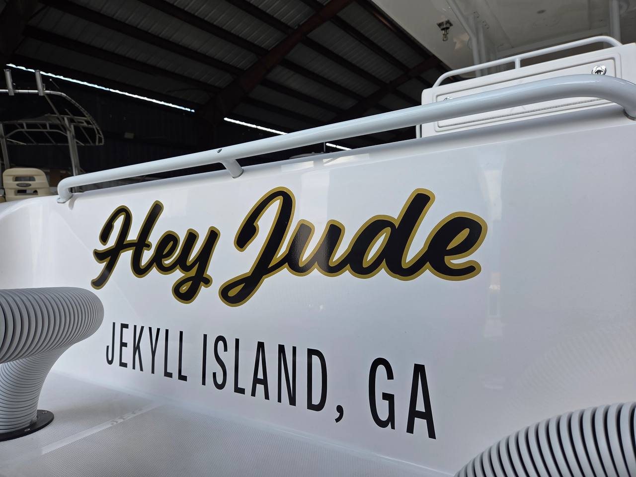 Hey Jude script boat name in black and gold with a Jekyll Island GA hailing port