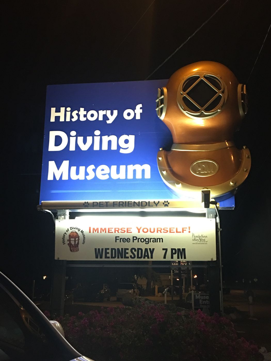 History of Diving Museum lit sign at night