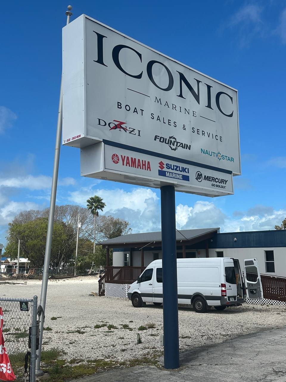 Iconic Marine boat sales and service pole sign with engine brand panels
