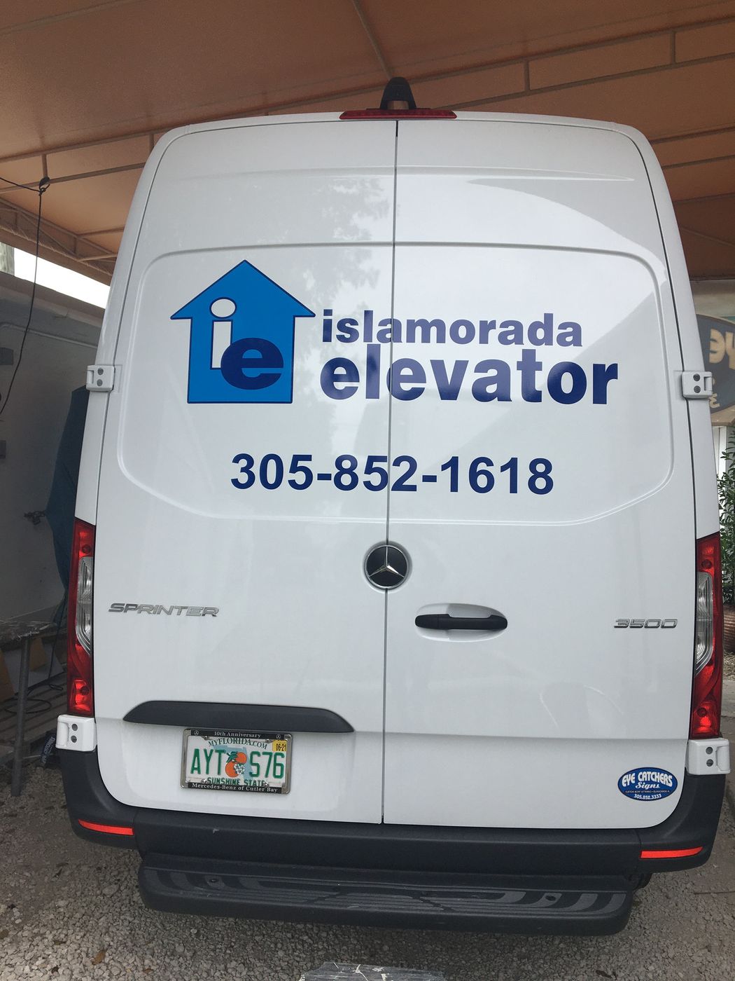 White van with Islamorada Elevator logo and phone number