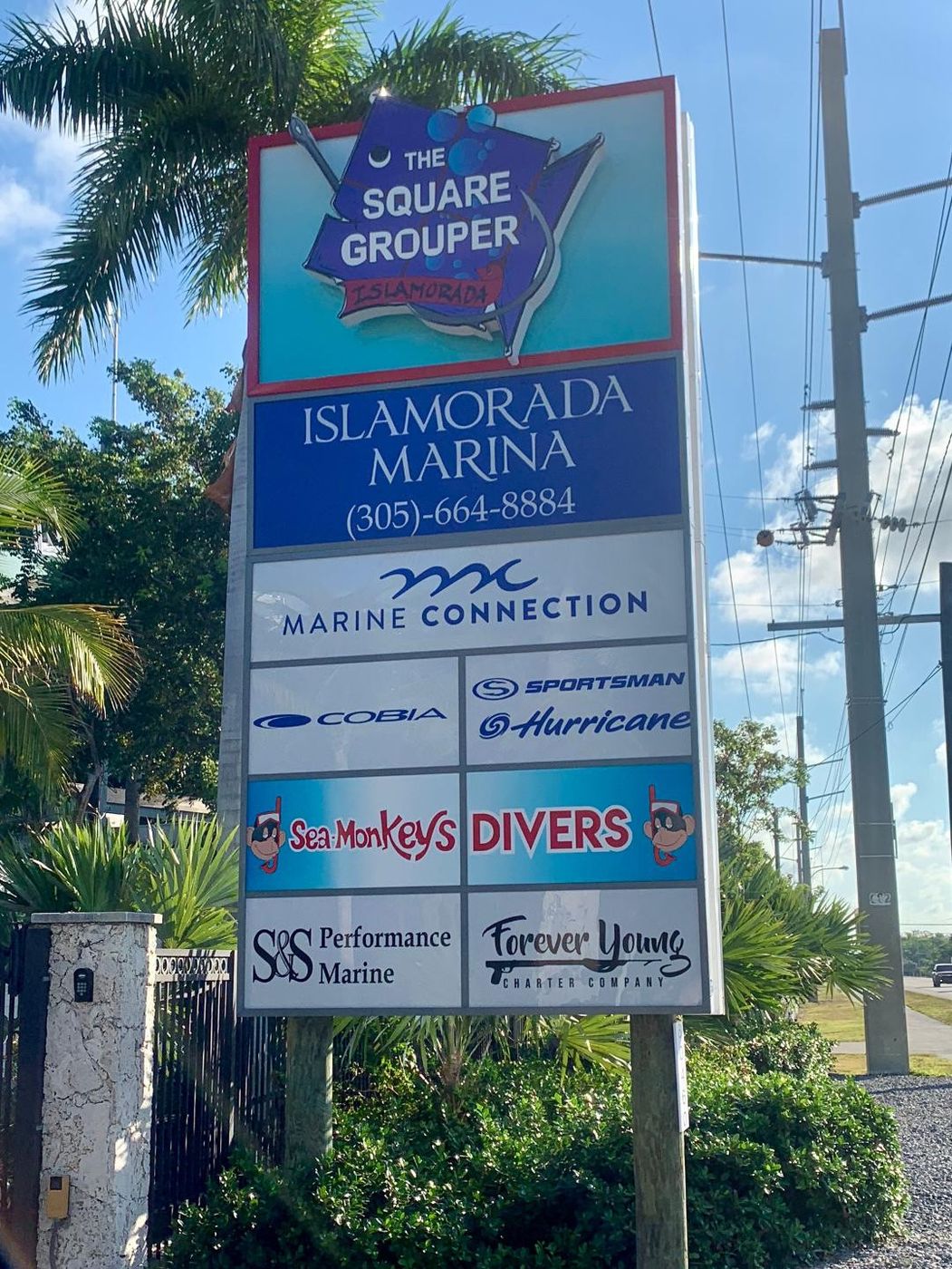 Tall Islamorada Marina pole sign with tenant panels