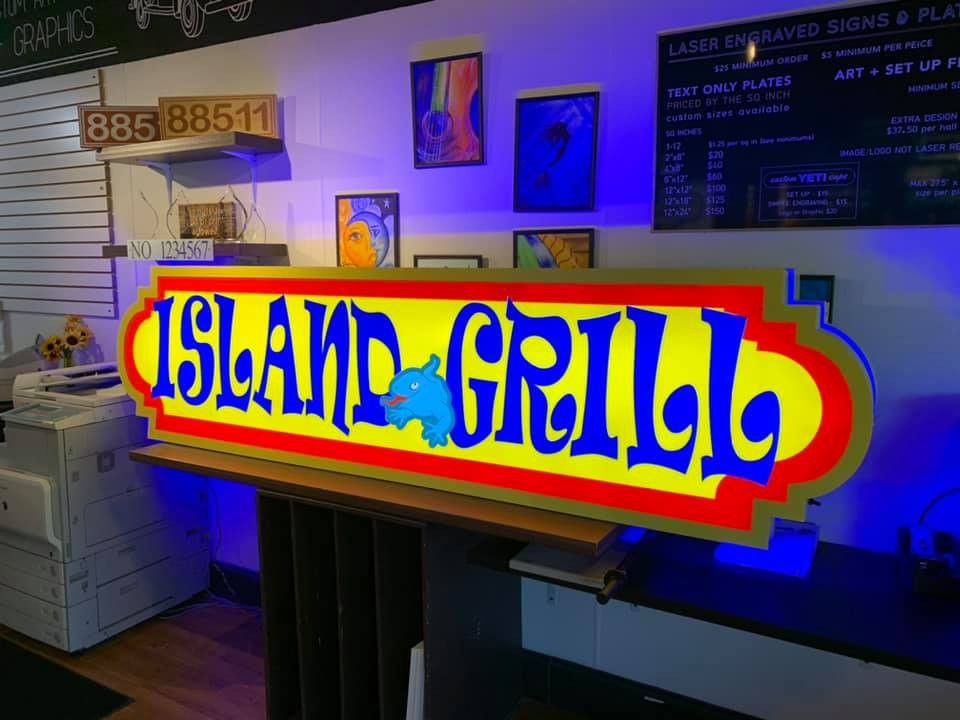 Lit Island Grill sign in red, yellow and blue