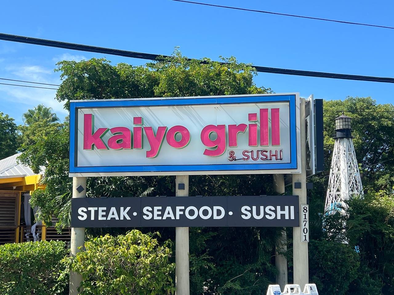 Kaiyo Grill and Sushi lit sign with a Steak, Seafood, Sushi panel