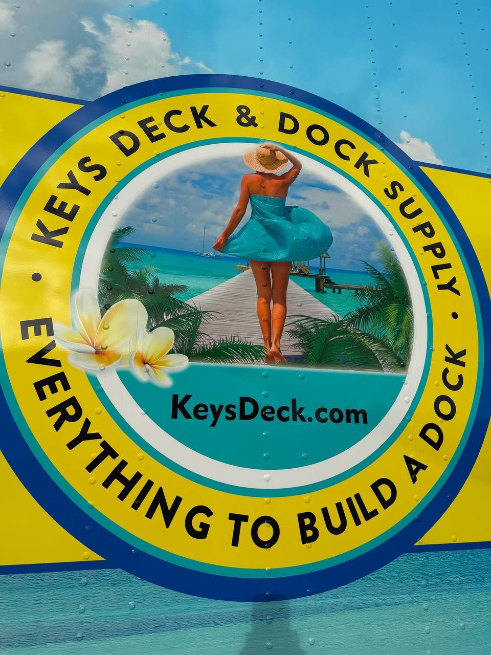 Close up of the Keys Deck & Dock Supply logo on the trailer wrap