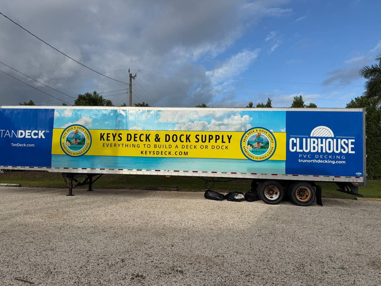 Semi trailer wrapped for Keys Deck & Dock Supply: Everything to Build a Deck or Dock, with TanDeck and Clubhouse PVC Decking panels