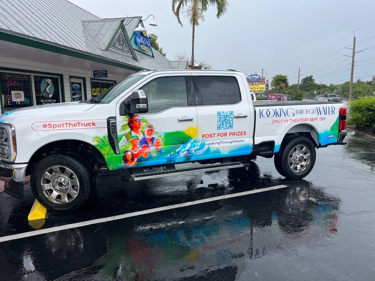 Pickup truck wrapped for the movie Looking Through Water with a QR code and water graphics