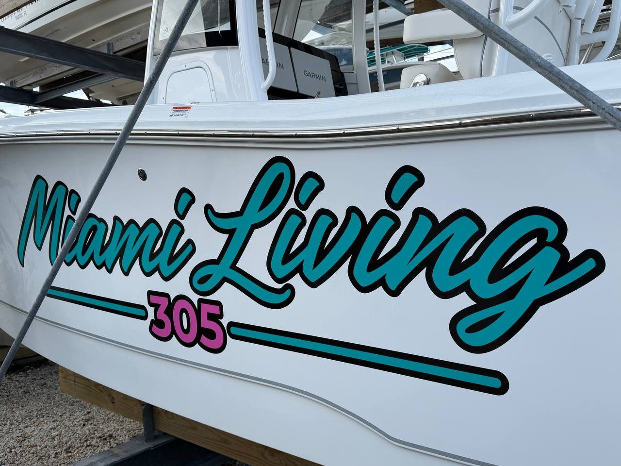 Miami Living 305 script lettering in teal and pink on a white center console