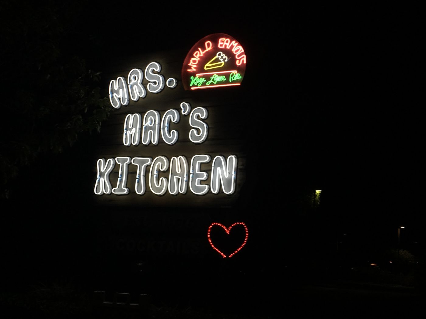 Glowing Mrs. Mac's Kitchen sign at night