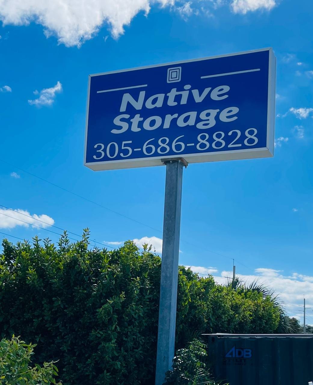 Blue Native Storage pole sign with phone number