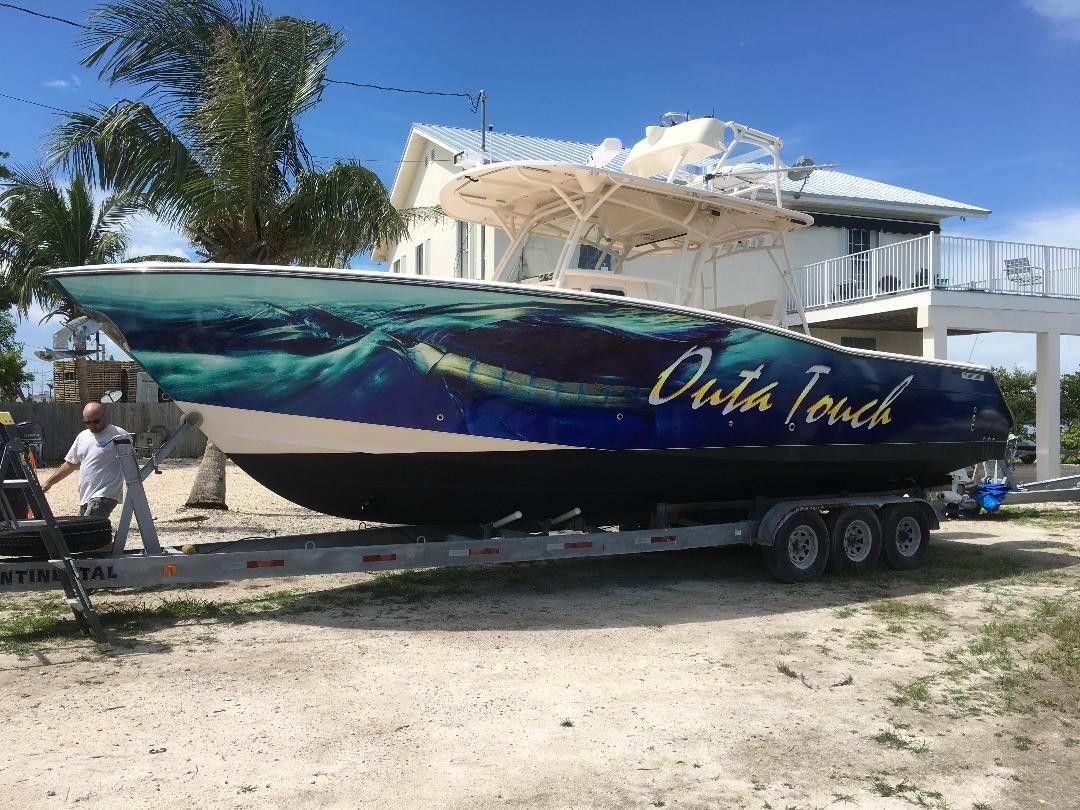 Outa Touch center console with a blue water fish wrap