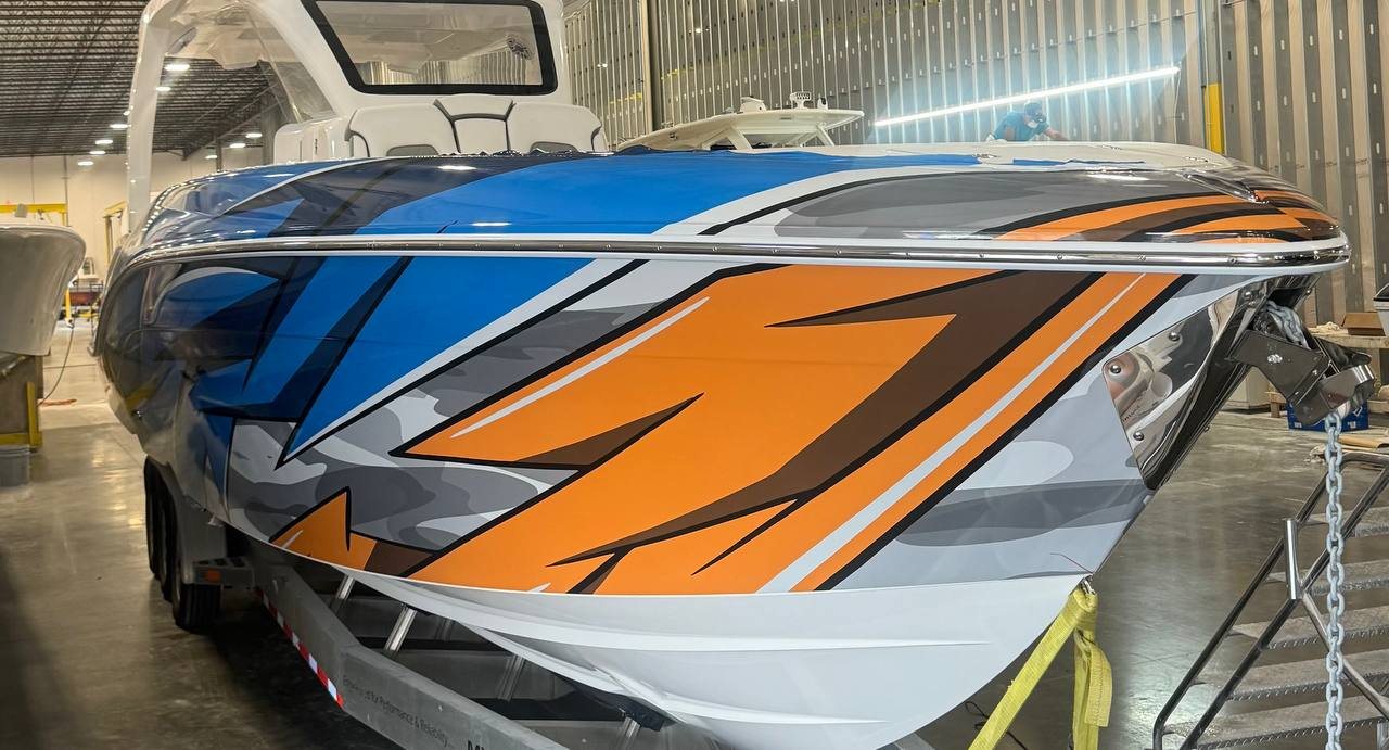 Bow of the 399 performance boat with orange and blue race graphics