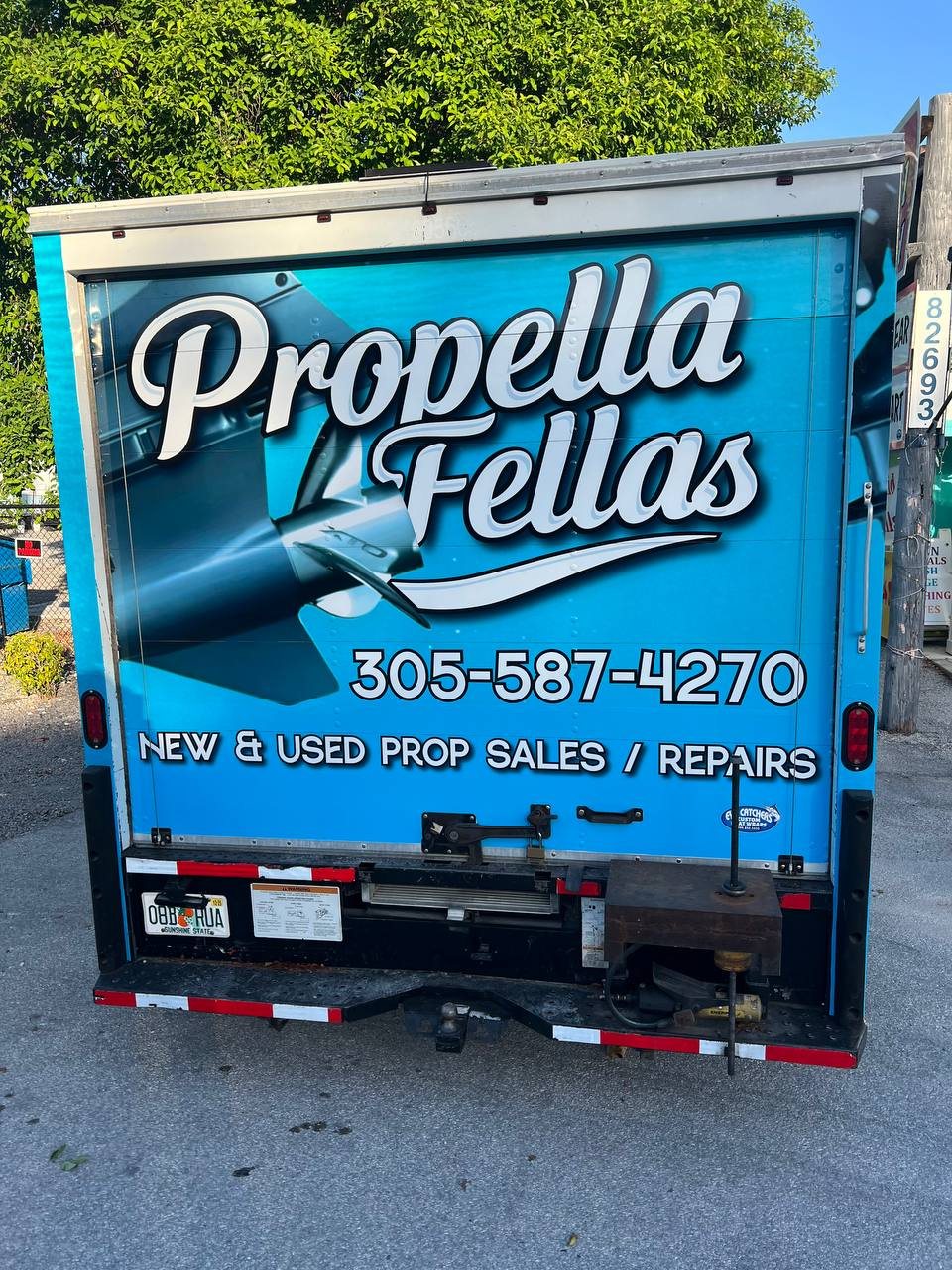 Rear door of the Propella Fellas box truck with logo and phone number