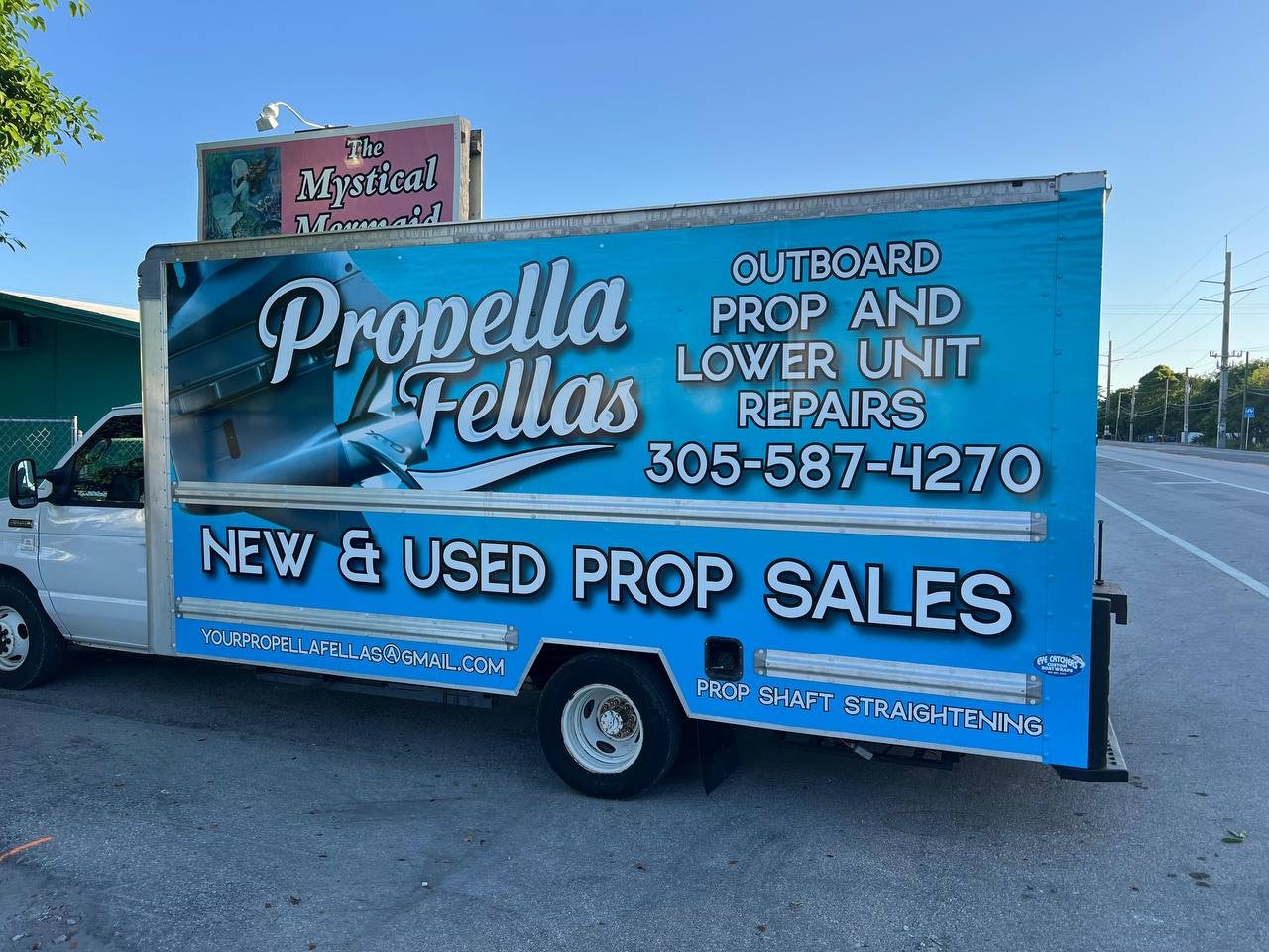 Box truck wrapped in blue for Propella Fellas outboard prop and lower unit repairs