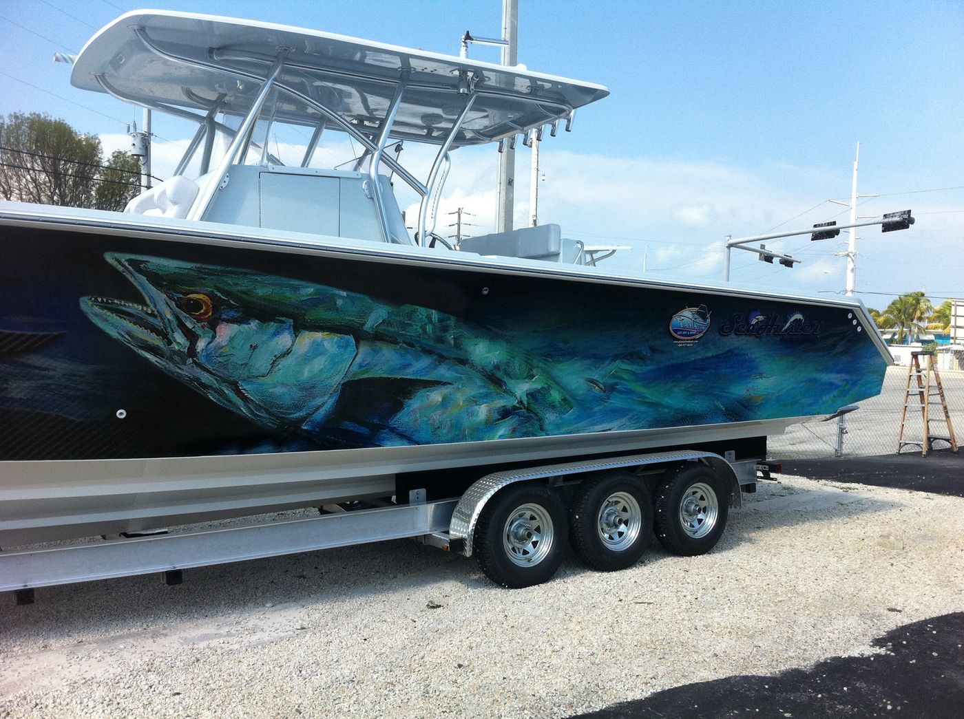 Center console with a giant tarpon wrapped along the hull