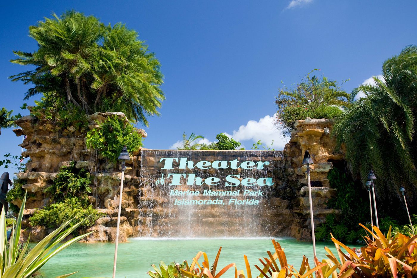 Theater of the Sea sign set in a rock waterfall