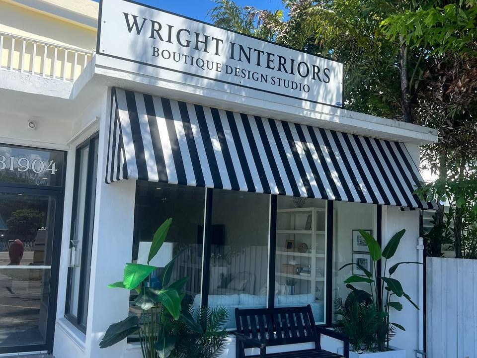 Black and white striped awning under the Wright Interiors Boutique Design Studio sign